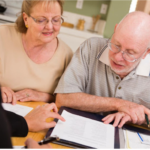 Senior couple reviewing paperwork with their attorney