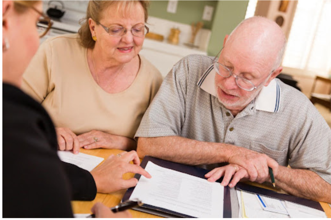 Senior couple reviewing paperwork with their attorney