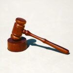 A wooden gavel on a stand